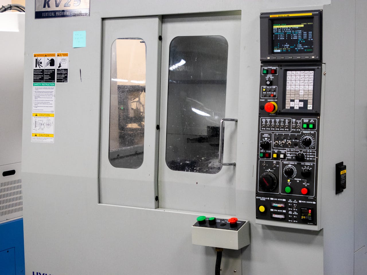 about-me-02 A modern CNC machine control panel used for precise industrial processes indoors.